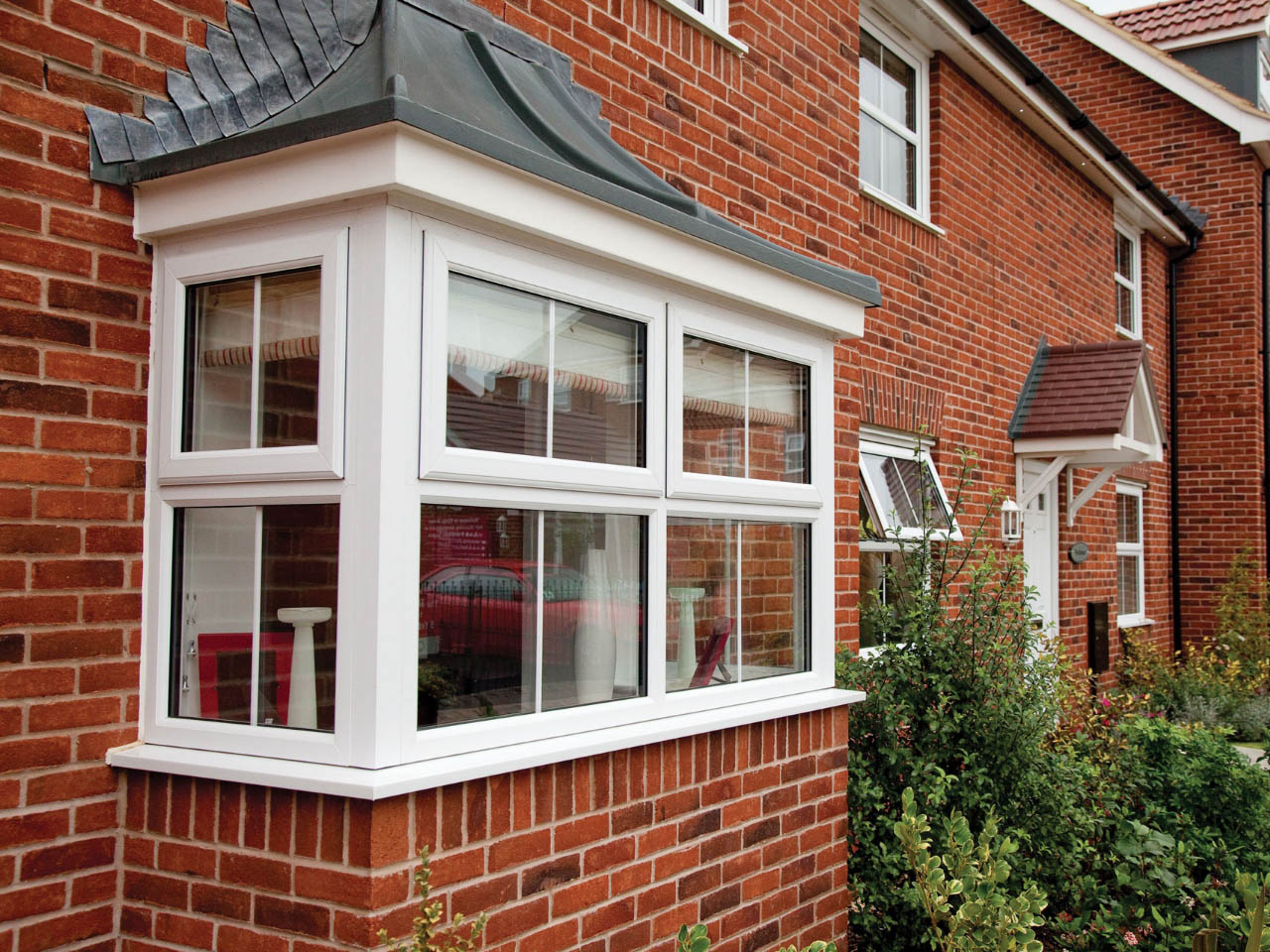 white upvc bay window in a red brick house