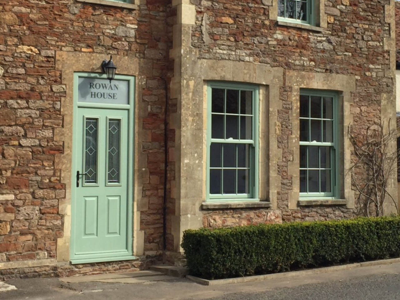 old fashioned house with green sliding sash windows